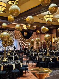 New years Eve gold centerpieces and gold ceiling balloons for a ballroom
