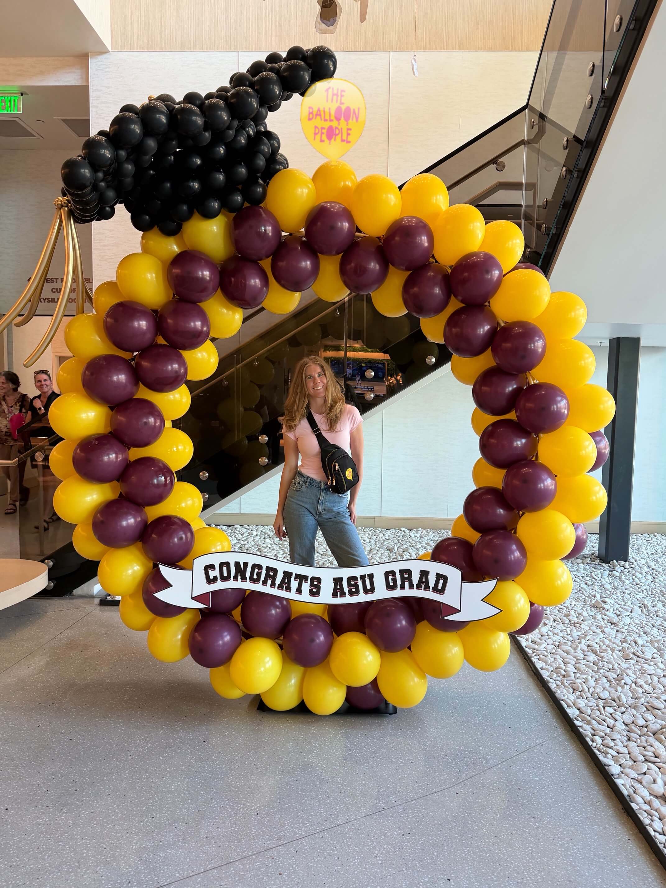 Graduation decor balloon hoop with grad cap and custom signage