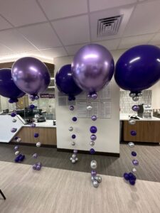 matching Balloon Centerpieces with Balloon Floor Bouquets provides a cohesive look throughout the event