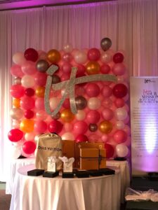 corporate branded Balloon with signage behind a product table