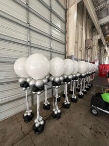 tall, air-filled Balloon Centerpieces ready to be placed on tables.