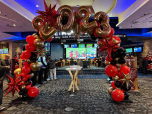 ringing in the new year with vibrant Balloon Arches in black, gold and red