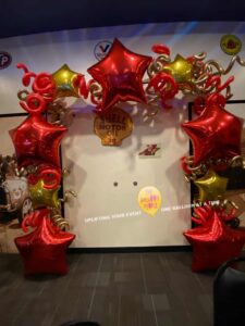 festive Balloon wall framed with big red stars