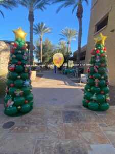 christmas trees made out of Balloons on a sidewalk in tempe