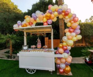 Balloon Garlands over a candy cart outside