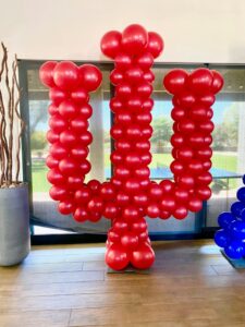 red trident logo made out of Balloons