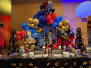 superhero Balloon decorations over a food table