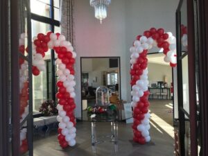 tall Balloon candy canes at the entrance of a business