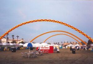 giant Balloon Arches in different patterns over a carnival