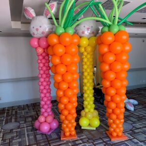 Easter themed Balloon decorations including giant carrots made out of Balloons