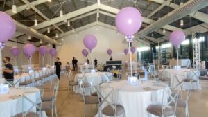bright pink Balloons float above tables