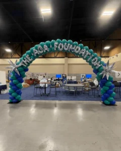 Balloon arch with text at a convention booth